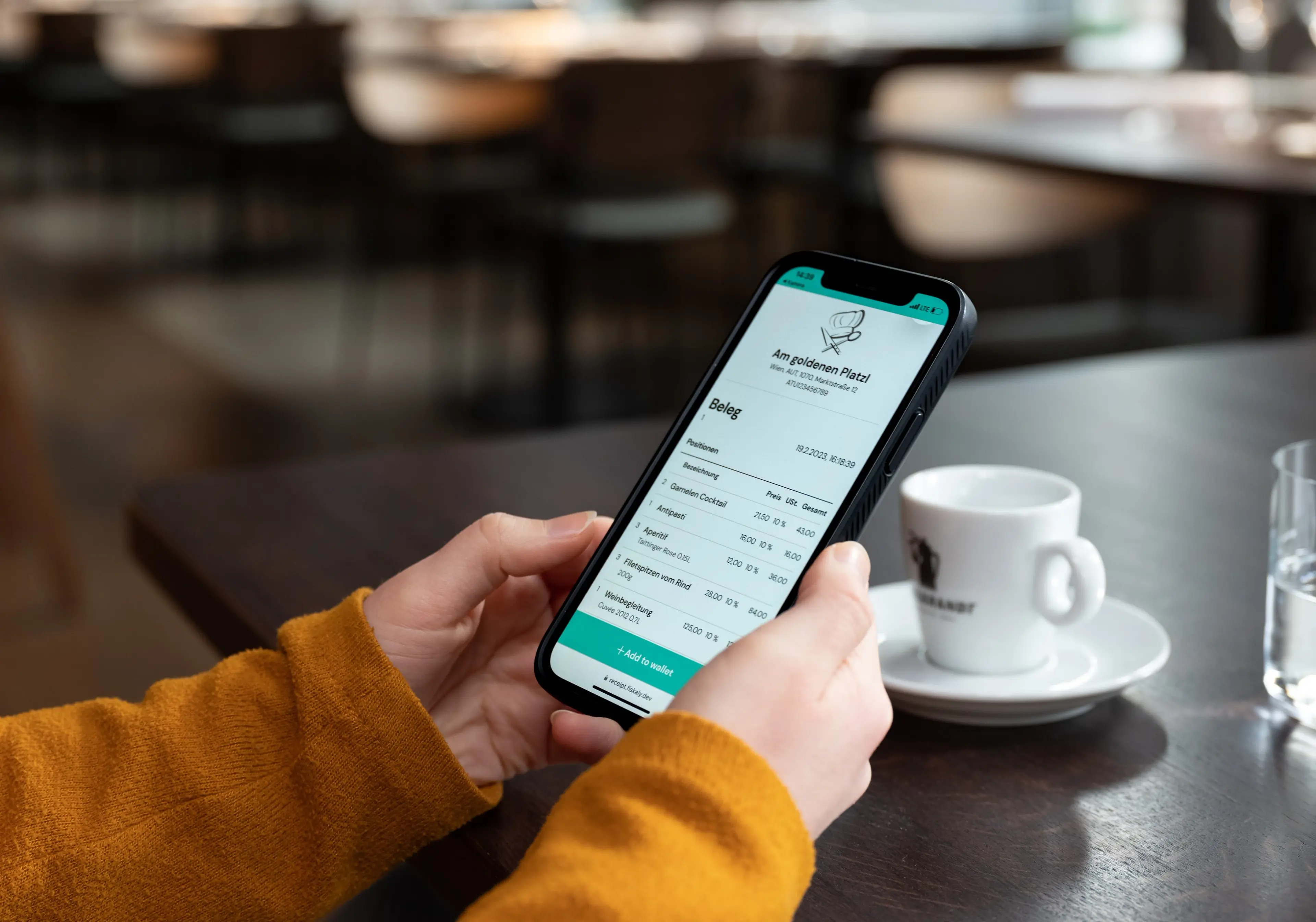 Person's hands, holding a cell-phone with a digital receipt details on the screen