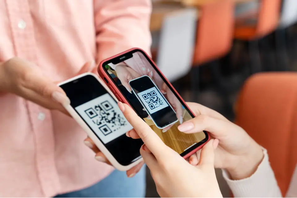 A person scans a QR code to get a digital receipt for purchase
