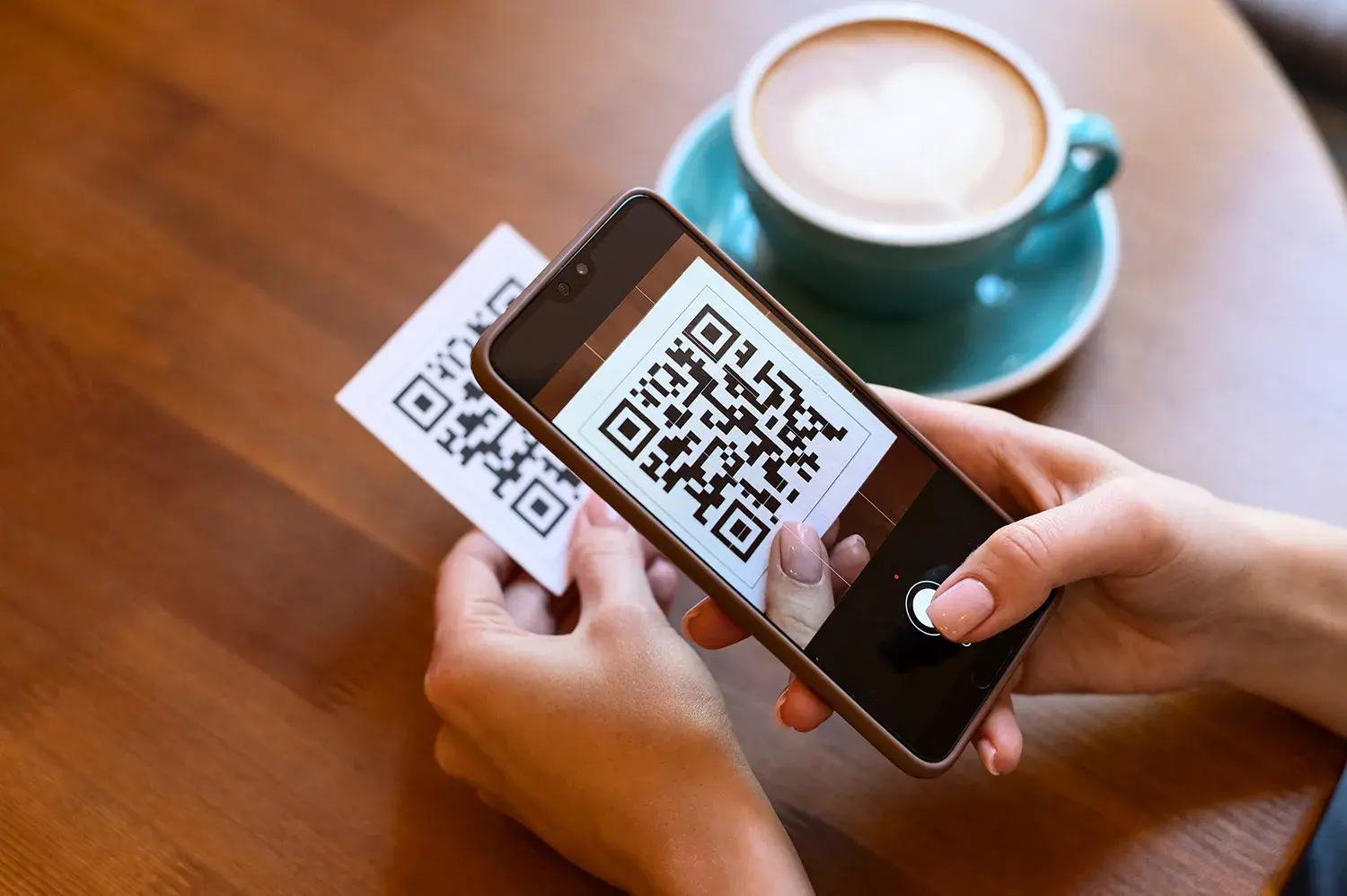 A person takes a picture of the QR code to complete the payment